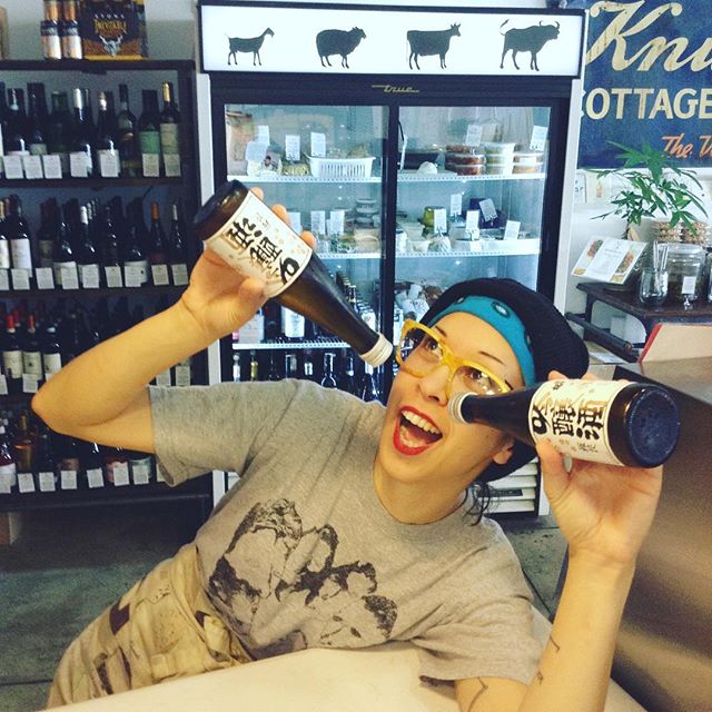 Devra drinking 2 sake bottles at once.
